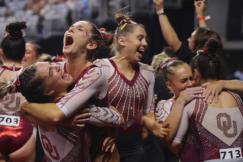 Oklahoma team celebrates their victory together after the NCAA college women's gymnastics championships, Saturday, April 16, 2022, in Fort Worth, Texas. (AP Photo/Gareth Patterson)