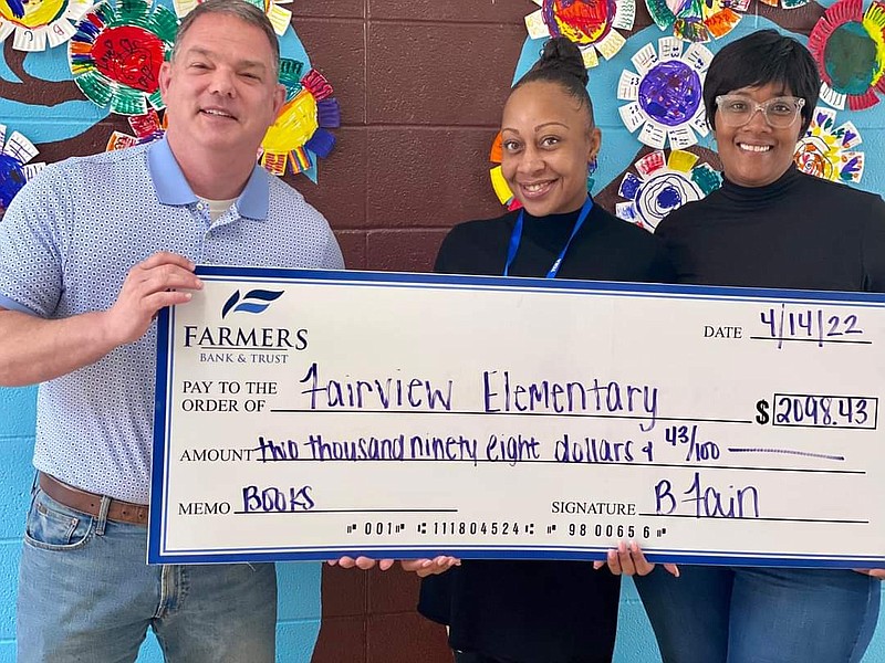 Courtesy Photo
Blake Fain, President of the Camden Market at Farmers Bank and Trust delivers a check to Camden Fairview Elementary School. The donation will be used to purchase  instructional material for  students in Fall 2022