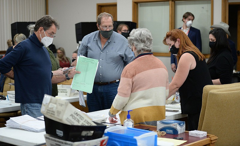 Jennifer Price (right), Washington County's election director,   speaks Tuesday, Nov. 3, 2020, with poll workers as absentee ballots are counted at the Washington County Courthouse in Fayetteville. (NWA Democrat-Gazette/Andy Shupe)