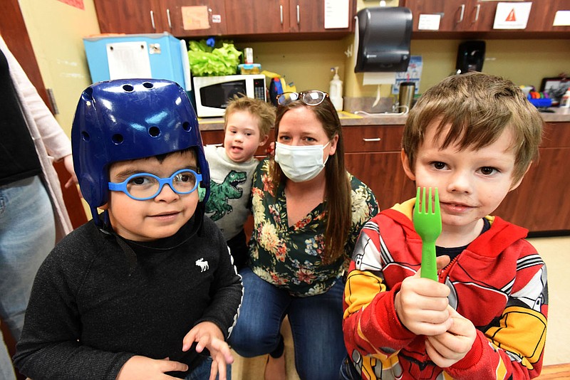 Sarah Pollack, in charge of philanthropy, plays with students on Wednesday March 17 2021 at the Benton County Sunshine School and Development Center in Rogers.
(NWA Democrat-Gazette/Flip Putthoff)