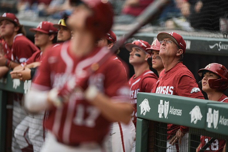 Arkansas head coach Dave Van Horn, second from right, watches a foul ball during the first inning of the Razorbacks' 4-0 win over LSU at Baum-Walker Stadium in Fayetteville Friday. - Photo by Hank Layton of NWA Democrat-Gazette