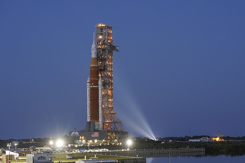 FILE - The NASA Artemis rocket with the Orion spacecraft aboard leaves the Vehicle Assembly Building moving slowly on an 11-hour journey to pad 39B at the Kennedy Space Center in Cape Canaveral, Fla., Thursday, March 17, 2022. The flight debut of NASA's new mega moon rocket faces additional delays, following a series of failed fueling tests, officials said Monday, April 18, 2022. (AP Photo/John Raoux, File)