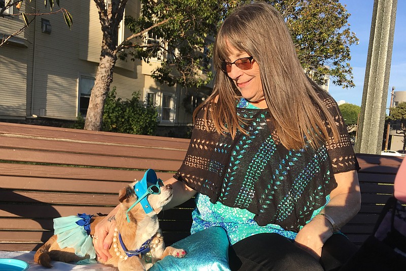 Diana McAllister lounges with her dog, Honey, at a park in San Francisco. Some pet owners in the area report waiting months for veterinarian appointments. (April Dembosky/KQED/KHN/TNS)