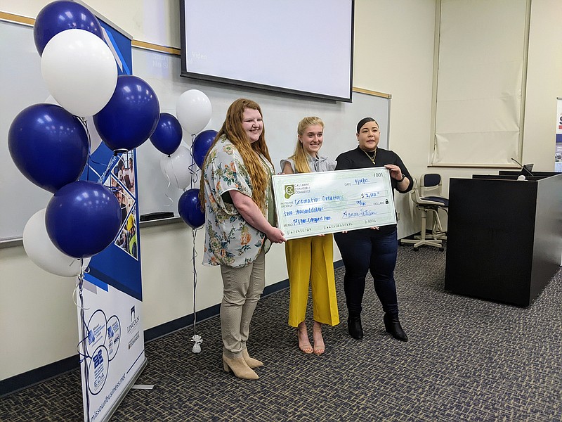 Brianna Kliethermes (left) and Lauren Carter (right) present Paige Brennecke (center) with a check for $2,000 after she won the Callaway Chamber of Commerce’s first Show Me Innovation Collegiate Pitch Competition on Tuesday. Brennecke pitched an idea to incorporate cremated ashes in ceramic art as a way to preserve remains. photo by Ryan