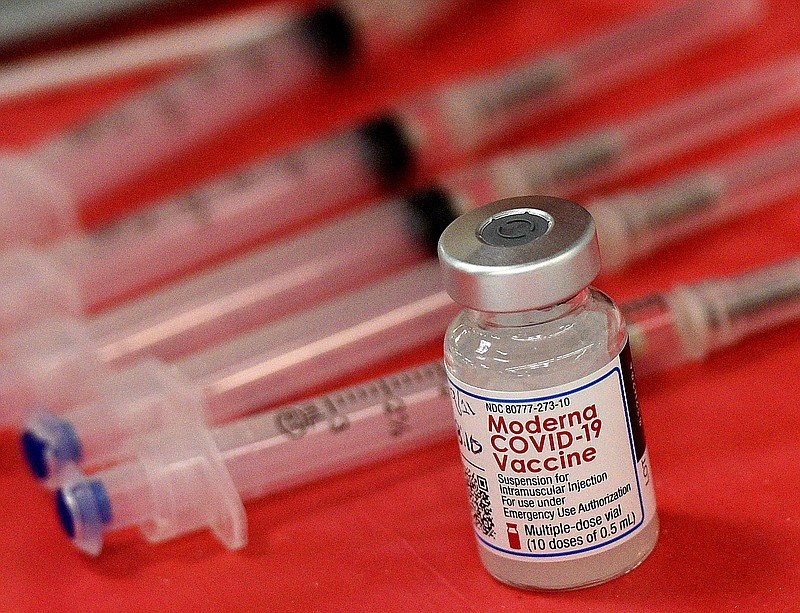 FILE - Syringes and a vial of the Moderna COVID-19 vaccine are displayed at a mass COVID-19 vaccination site in Batavia, Ill., on March 19, 2021. Moderna hopes to offer updated COVID-19 boosters in the fall that combine its original vaccine with protection against the omicron variant. On Tuesday, April 19, 2022, it reported a preliminary hint that such an approach might work. (Rick West/Daily Herald via AP, File)