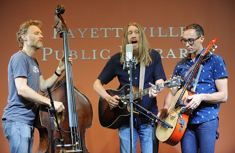 Chris Wood (from left), Oliver Wood and Jano Rix, all members of the musical group The Wood Brothers, perform during a live broadcast by KUAF as a part of the 2017 Fayetteville Roots Festival. The food and music festival returns Aug. 25-27 this year to Fayetteville's downtown square. 
(File Phooto/NWA Democrat-Gazette/ANDY SHUPE)