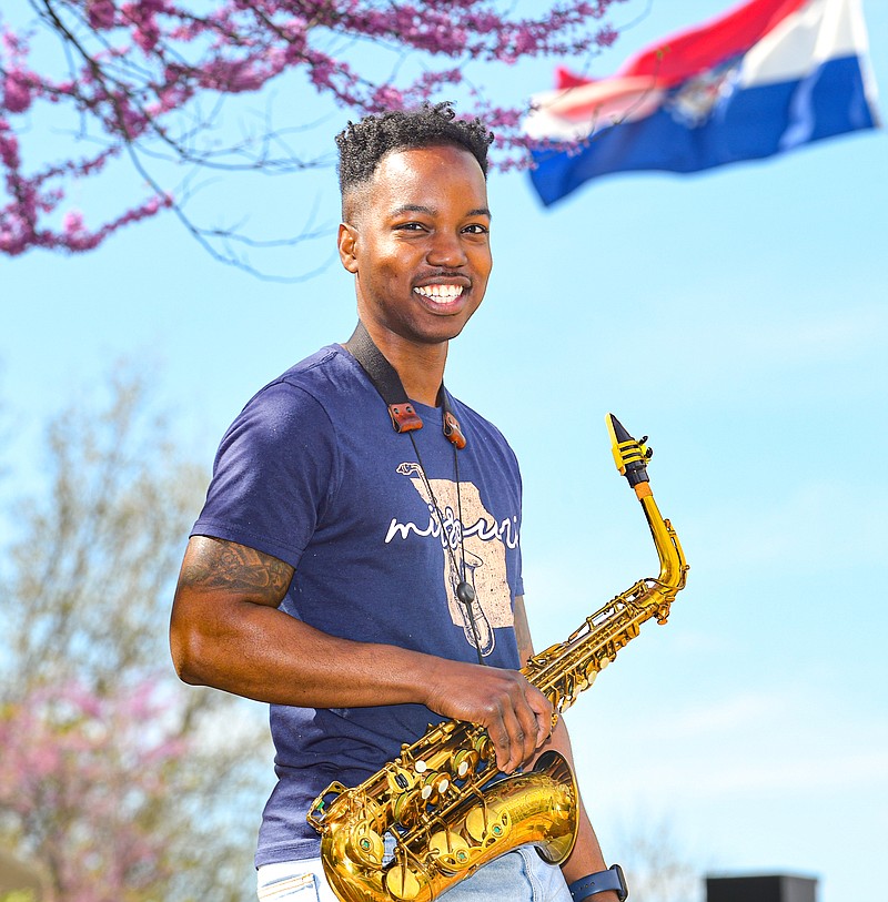 Julie Smith/News Tribune
Xavier Jordan poses with his saxophone outside of his work place. Jordan is a local saxophonist who will be playing in a MO musicians concert at the Capitol April 30.