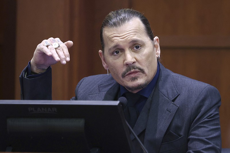 Actor Johnny Depp testifies in the courtroom at the Fairfax County Circuit Court in Fairfax, Va., Thursday, April 21, 2022. Actor Johnny Depp sued his ex-wife Amber Heard for libel in Fairfax County Circuit Court after she wrote an op-ed piece in The Washington Post in 2018 referring to herself as a "public figure representing domestic abuse." (Jim Lo Scalzo/Pool Photo via AP)