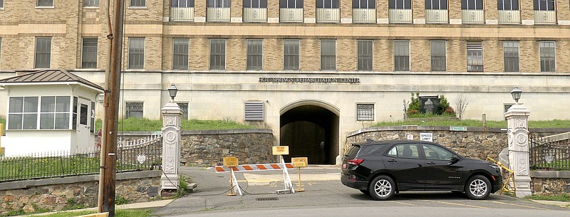 A vehicle, signs and a barricade block the front entrance to the Army and Navy General Hospital on Reserve Street on Thursday. - Photo by Donald Cross of The Sentinel-Record