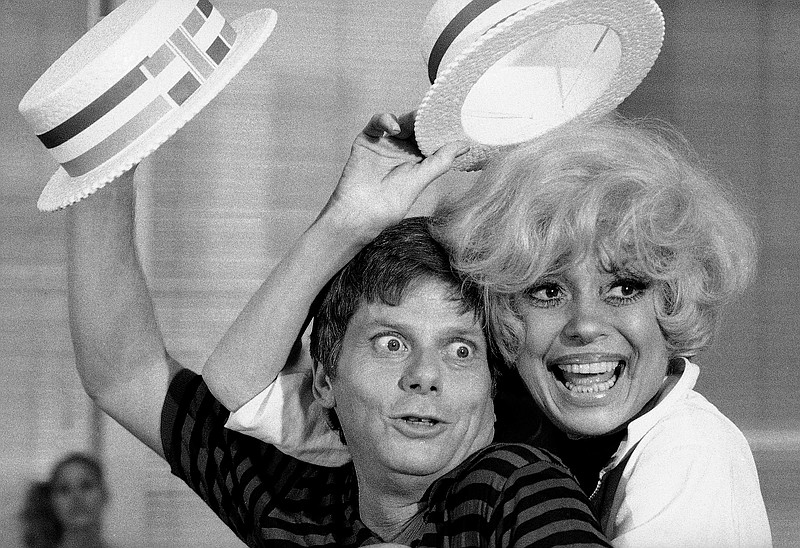 FILE - Robert Morse, left, and  Carol Channing appear during a rehearsal for the road company production of "Sugar Babies" in New York on July 18, 1977. Morse, who won a Tony Award as a hilariously brash corporate climber in “How to Succeed in Business Without Really Trying” and a second one a generation later as the brilliant, troubled Truman Capote in “Tru,” died peacefully at his home on Wednesday, April 20, at the age of 90.  More photos at arkansasonline.com/422morse/.
(AP Photo/Marty Lederhandler, File)