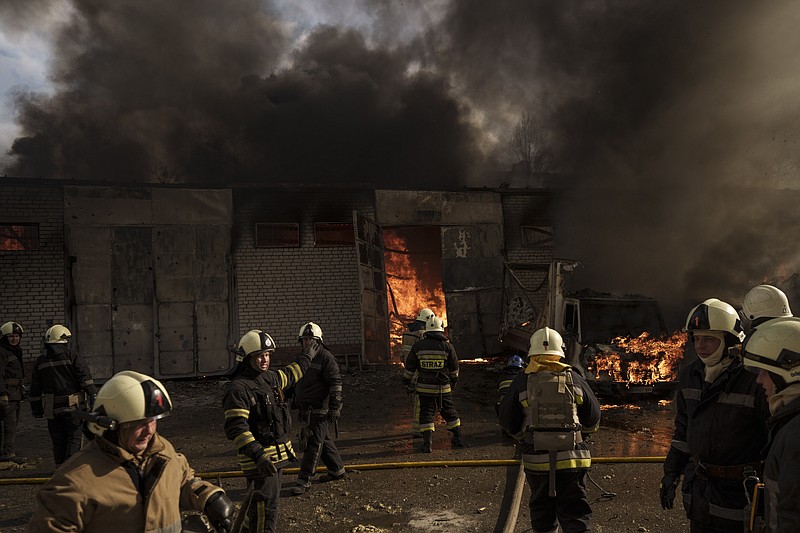 Firefighters battle a fire at a warehouse after a Russian bombardment in Kharkiv, Ukraine, Thursday, April 21, 2022. (AP Photo/Felipe Dana)