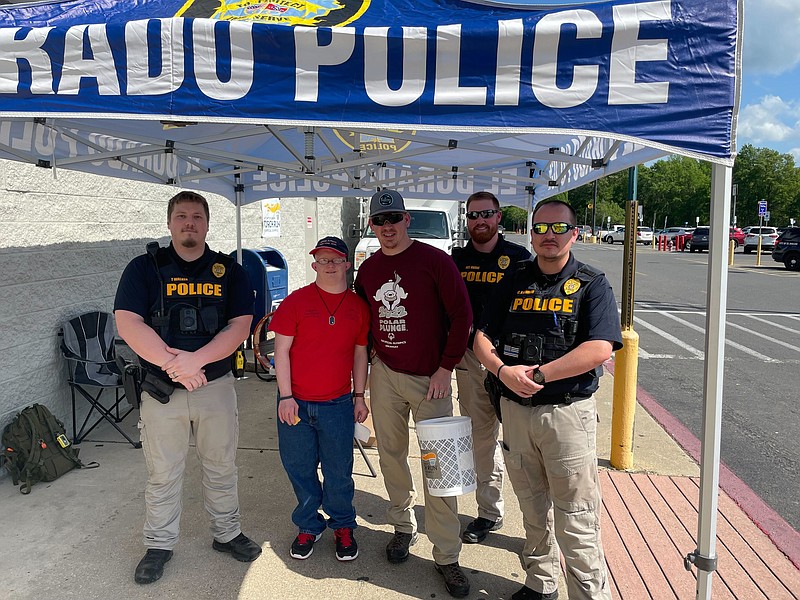 Some El Dorado Police officers spent Friday at Wal-Mart raising funds for the Special Olympics in Arkansas. Pictured from left to right are Patrolman Tyler Walker, Special Olympics Athlete Jason Mitchell, Detective Gerid Ardwin, Sgt. Logan Owens and Lt. Ryan Landers. (Matt Hutcheson/News-Times)