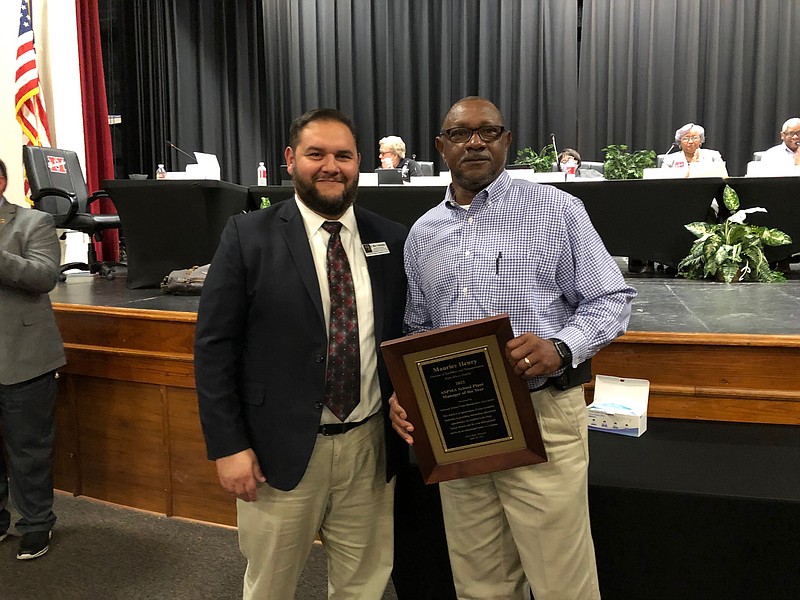 Hope Public Schools Facilities and Transportation director Maurice Henry, right, was named Arkansas Association of Education Administrators Plant Manager of the Year during the Monday, April 18, 2022, meeting of the Hope Public Schools Board of Education. Dr. Mike Hernandez, executive director of the AAEA, left, made the presentation to Henry. (Photo courtesy of Ken McLemore/Hope Public Schools)