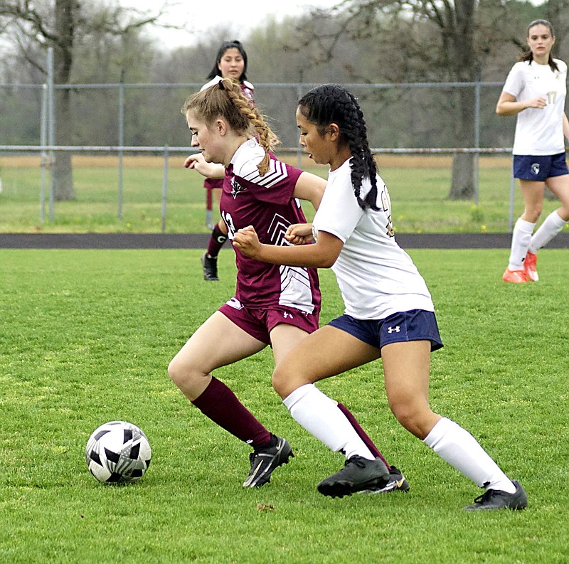 Westside Eagle Observer file photo/RANDY MOLL
Gentry's Cayci Capps battles a Shiloh Christian player in an attempt to gain control of the ball during play against Shiloh Christian on Tuesday, April 12, at Gentry High School.
