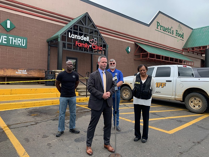 DEA agents Jared Harper, at microphone, and Connie Overton, right, speak with media Tuesday, May 18, 2021, outside Lansdell Family Clinic in De Queen, Arkansas. Lansdell Family Clinic PLLC and Lansdell Farms LLC face a number of federal charges, including conspiracy to distribute opiates, health care fraud and wire fraud involving the misuse of pandemic relief funds. (Gazette file photo)