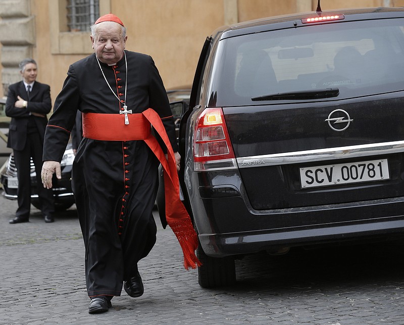 FILE - Cardinal Stanislaw Dziwisz arrives for a meeting at the Vatican, Friday, March 8, 2013. A Vatican investigation into allegations that Dziwisz, the former top aide to St. John Paul II was negligent in handling sex abuse claims in his native Poland has cleared him of wrongdoing, the Vatican&#x2019;s embassy in Poland said Friday, April 22, 2022. (AP Photo/Alessandra Tarantino, File)