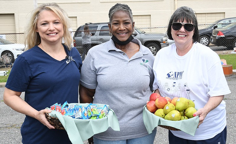 From left, Priscilla Couch, emergency room director at NPMC, Janice Davis, founder of The Giving Team, and Ruth Anne Milbourn, chest pain center coordinator at NPMC set up at the monthly Food for Thought event. - Photo by Tanner Newton of The Sentinel-Record