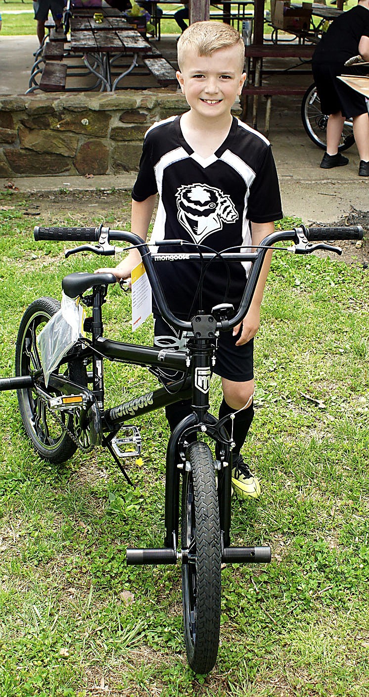 Westside Eagle Observer/RANDY MOLL
Parker McBride, 7, was a bicycle winner in Saturday's Easter egg hunt sponsored by the Gentry Chamber of Commerce.