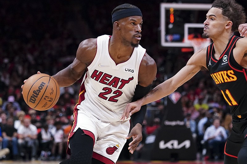 Miami Heat forward Jimmy Butler (22) drives against Atlanta Hawks guard Trae Young (11) in the first half of an NBA playoff basketball game Sunday, April 24, 2022, in Atlanta. (AP Photo/John Bazemore)