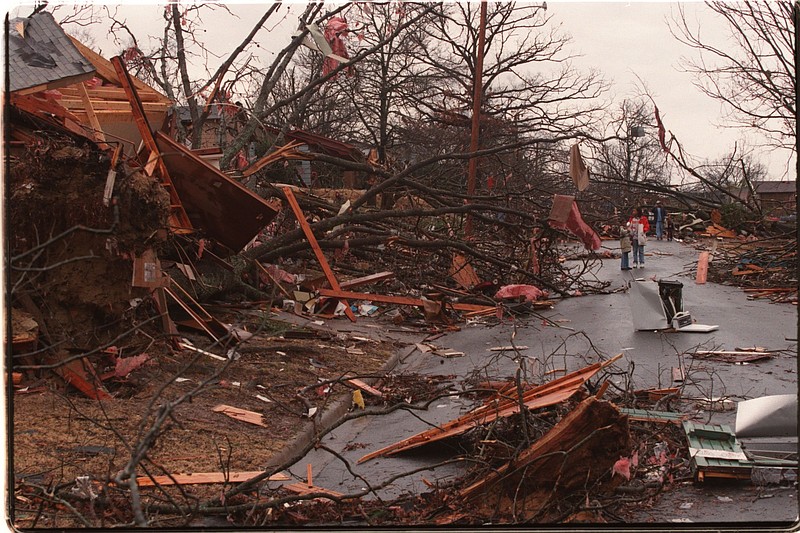 Residents survey the damage in the 3200 block of Battery Street on the Friday morning after a tornado hit the Little Rock area in January 1999. (Democrat-Gazette file photo)