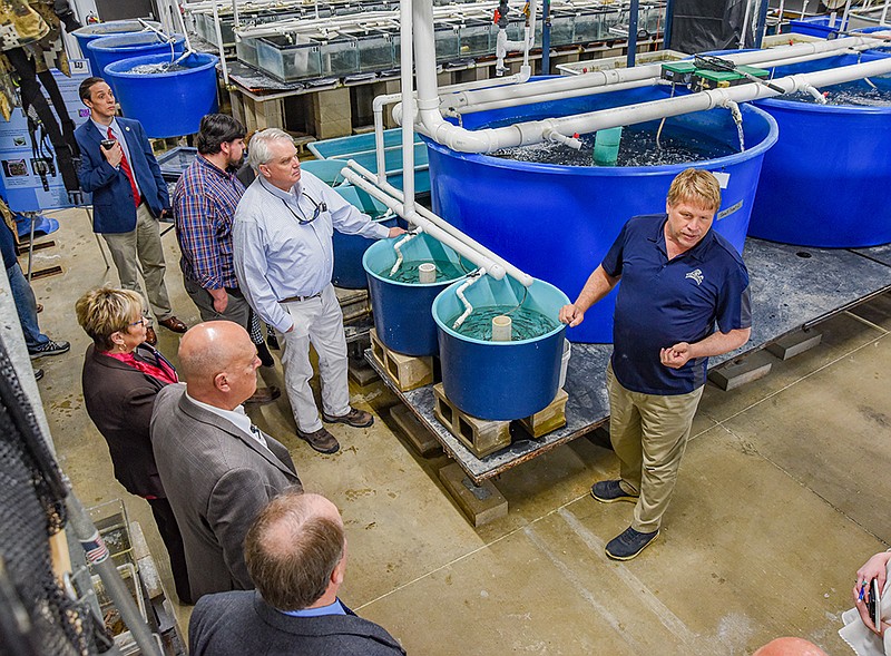 Jim Wetzel, right, leads a tour Monday for legislators and staffers of legislators serving on the Agriculture Policy Committee during their visit to the Lincoln University Aquaculture facility at Carver Farm on Bald Hill Road. Wetzel is an associate professor of animal science at the land grant university. (Julie Smith/News Tribune)