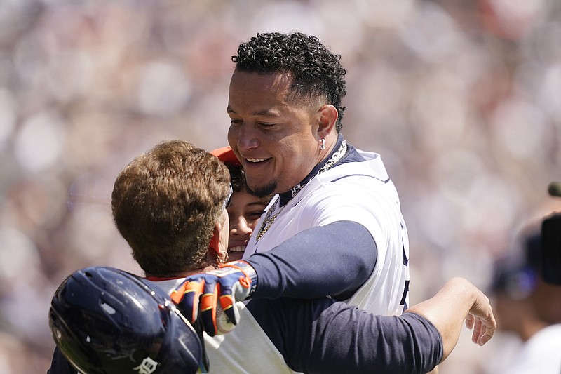 Detroit Tigers designated hitter Miguel Cabrera greets his family after his 3,000th career hit during the first inning of the first baseball game of a doubleheader against the Rockies, Saturday, April 23, 2022, in Detroit. (AP Photo/Carlos Osorio)