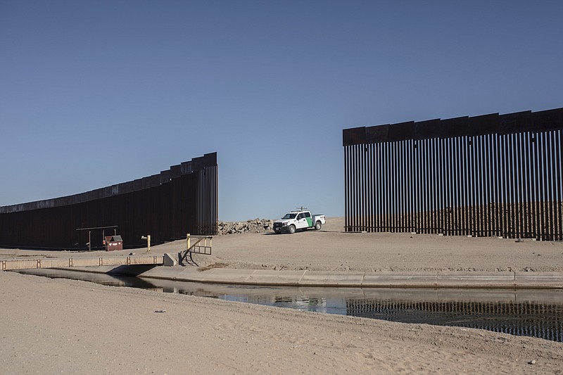 FILE - A Customs and Border Protection vehicle waits for a group of Nicaraguan migrants as they walk towards the US border to turn themselves in and ask for asylum, from Algodones, Mexico, Dec. 2, 2021. The Biden administration released a plan Tuesday to deal with an increase in already historic numbers of migrants at the U.S.-Mexico border with the lifting of a public health order that has kept people from seeking asylum — and that Republican and some Democratic lawmakers say should be kept in place. (AP Photo/Felix Marquez, File)