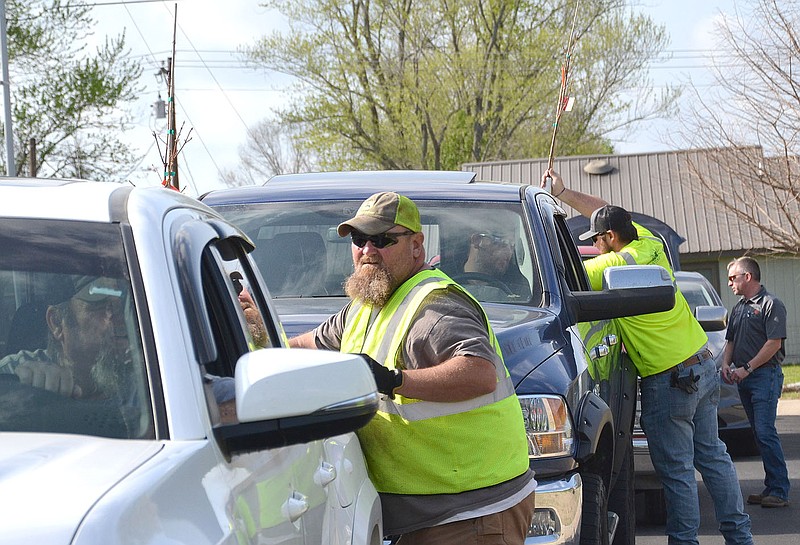 City employees Monte Keene, Hagan Schader and Nathan See assisted city residents with loading trees in their vehicles Friday, April 22.