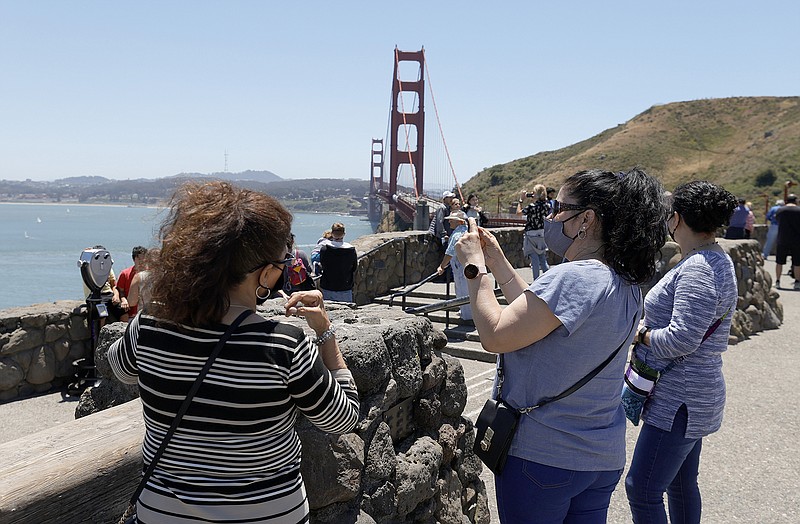 Tourists gather at a Golden Gate Bridge vista point on June 15, 2021, in Sausalito, California. (Justin Sullivan/Getty Images/TNS)