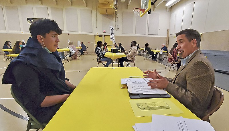 Juan Ramirez, middle school student, goes through a mock interview Tuesday, April 26, 2022, with Michael Beaumont,  Fort Smith School District athletics director, to discuss his interest in becoming a high school soccer coach. (NWA Democrat-Gazette/Monica Brich)