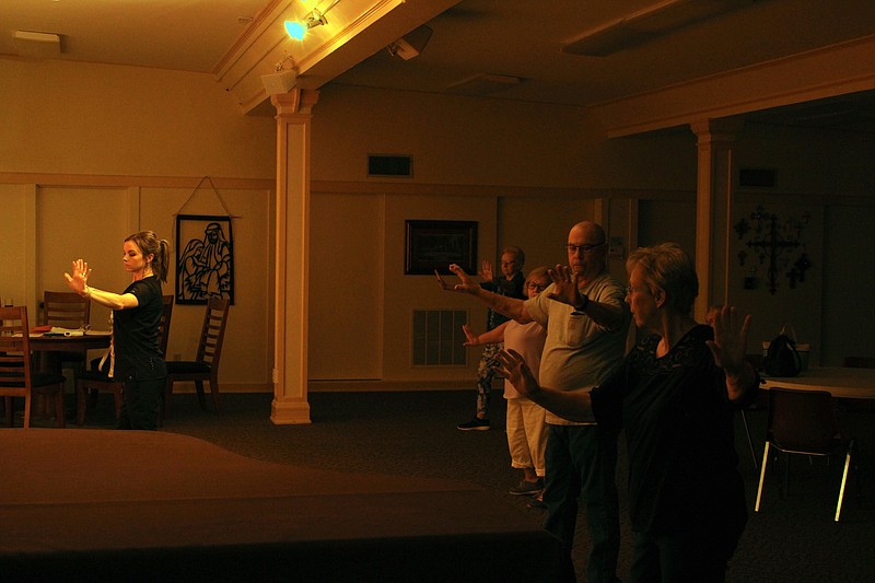 UAMS Center on Aging Assistant Education Director Jordan Turner, RN, left, leads a Tai Chi for Arthritis class on Thursday at the First United Methodist Church. (Caitlan Butler/News-Times)