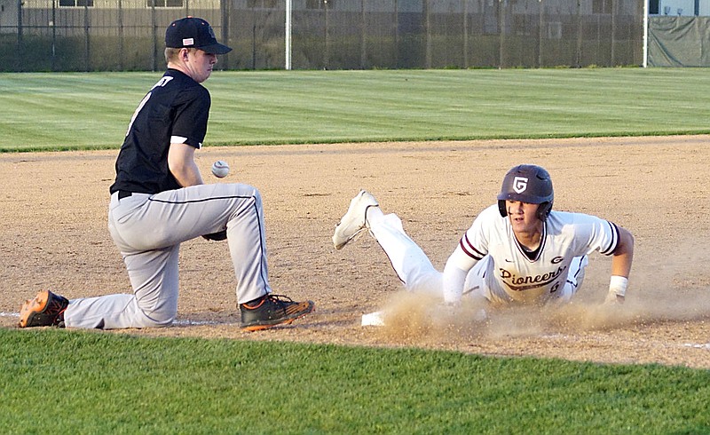 Westside Eagle Observer/RANDY MOLL
Gentry's Isaak Crittenden slides safely into third while Gravette third basaman Noah Tawney tries to get a handle on the ball during the April 25 tournament game in Gentry.