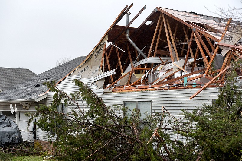 A house damaged by a severe storm is seen on Wednesday, March 30, 2022, along Black Oak Avenue in Springdale. A tornado touched down in Johnson around 4 a.m. before traveling into Springdale, damaging structures along Black Oak Avenue, Don Tyson Parkway and Turner and Powell streets. Two people were critically injured. Visit nwaonline.com/220331Daily/ for today's photo gallery.
(NWA Democrat-Gazette/Hank Layton)