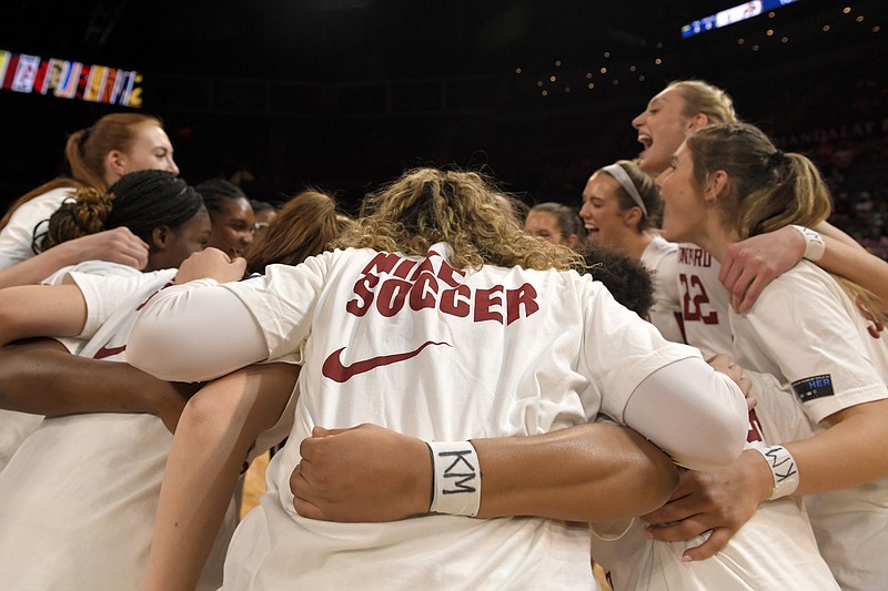 FILE - Stanford players huddle before an NCAA college basketball game against Oregon State while wearing warmup shirts honoring the school's soccer team goalkeeper Katie Meyer, who helped Stanford win a national championship, in the quarterfinals of the Pac-12 women's tournament, March 3, 2022, in Las Vegas. There has been a lot of talk about the mental health struggles that many young athletes face, the pressures and vulnerabilities that can seem overwhelming — especially to those who feel compelled to shield their pain from the outside world. (AP Photo/David Becker, File)