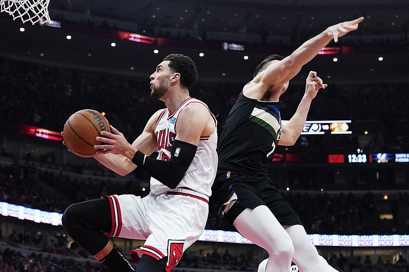 Chicago Bulls guard Zach LaVine, left, drives to the basket past Milwaukee Bucks guard Grayson Allen during the first half of Game 4 of a first-round NBA basketball playoff series, Sunday, April 24, 2022, in Chicago. (AP Photo/Nam Y. Huh)