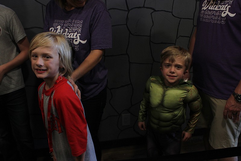 Colton and Cayden Crawford wait in line to meet actor Lou Ferrigno at Gabe's Cave on Friday. (Caitlan Butler/News-Times)
