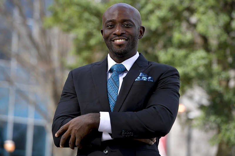 Dr. Dare Adewumi poses for a portrait, Tuesday, March 15, 2022, in Atlanta. Adewumi was thrilled when he was hired to lead the neurosurgery practice at Wellstar Cobb Hospital in Austell, Ga., in the Atlanta-area near where he grew up. But he says he quickly faced racial discrimination that ultimately led to his firing and has prevented him from getting permanent work elsewhere. His lawyers and other advocates say he's not alone. (AP Photo/Mike Stewart)