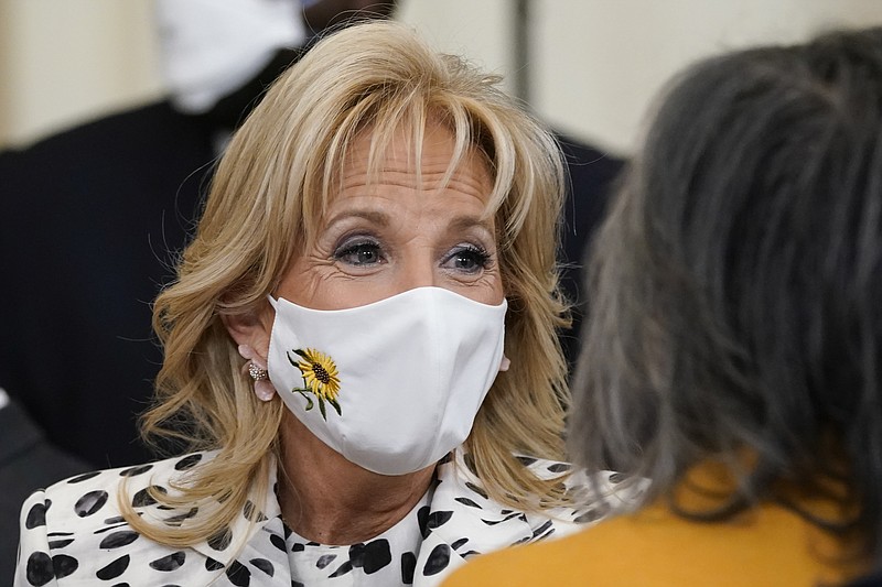 FILE - First lady Jill Biden wears a mask with a sunflower, the national flower of Ukraine, in support of the Ukrainian people at an event to celebrate Black History Month in the East Room of the White House, Feb. 28, 2022, in Washington. The White House has announced that Jill Biden will meet with Ukrainian refugees during a trip to Romania and Slovakia later this week. The first lady will visit both eastern European countries during a five-day trip that starts Thursday. Romania and Slovakia share borders with Ukraine. (AP Photo/Patrick Semansky, File)