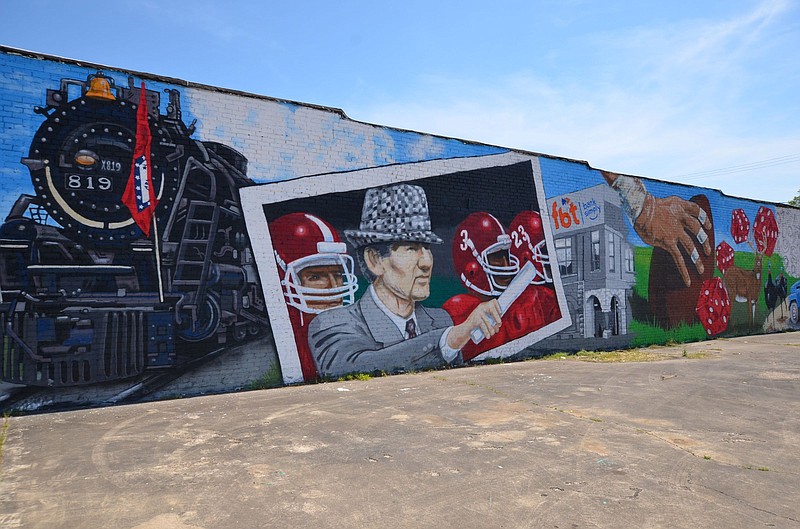 The newly completed mural at the corner of Fourth and Main streets at Fordyce highlights regional icons including the 819 steam engine that pulled Cotton Belt trains through town and native son, Alabama football Coach Paul ?Bear? Bryant. (Special to The Commercial/Richard Ledbetter)