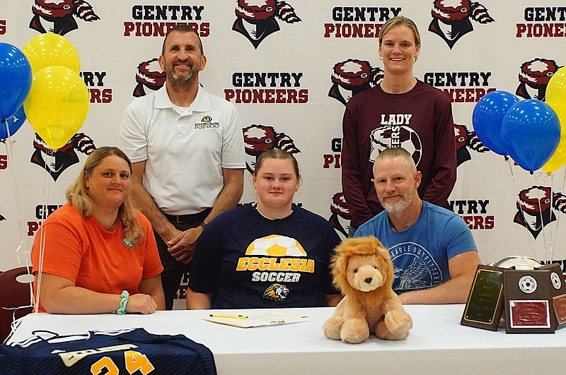 Westside Eagle Observer/RANDY MOLL
Gentry senior and four-year soccer player Kailey Ward (center) signed her letter of intent  to attend Ecclesia College in Springdale and play on the women's soccer team there next year. She was accompanied by her parents, Aaron and Christina Ward (seated); Craig Clayton, head women's coach at Ecclesia college; and Jamie Johnston, Gentry head coach of the girls' soccer team .