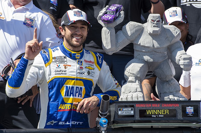 Chase Elliott gestures next to his trophy after a NASCAR Cup Series auto race at Dover Motor Speedway, Monday, May 2, 2022, in Dover, Del. (AP Photo/Jason Minto)