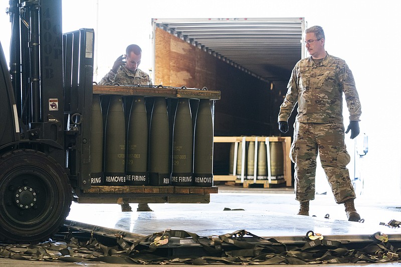Airmen with the 436th Aerial Port Squadron place 155 mm shells on aircraft pallets ultimately bound for Ukraine, Friday, April 29, 2022, at Dover Air Force Base, Del. President Joe Biden asked Congress on Thursday for $33 billion to bolster Ukraine's fight against Russia, signaling a burgeoning and long-haul American commitment. (AP Photo/Alex Brandon)