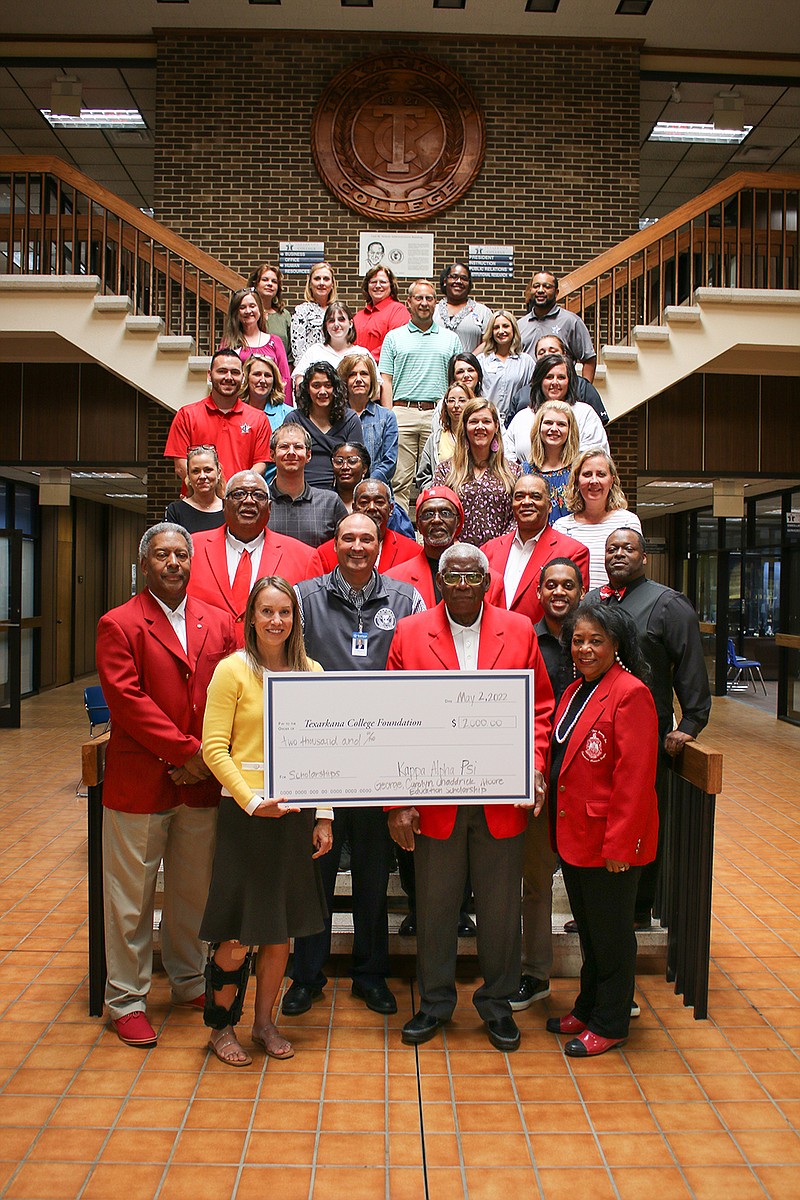 Members of Kappa Alpha Psi fraternity and representatives from Texarkana College pose with a check symbolic of a $4,000 donation to the Moore Family Education Scholarship at the college. George and Carolyn Moore, the scholarship's namesakes, are at front right. The couple are longtime educators, and George Moore is a member of the TC board. (Submitted photo)