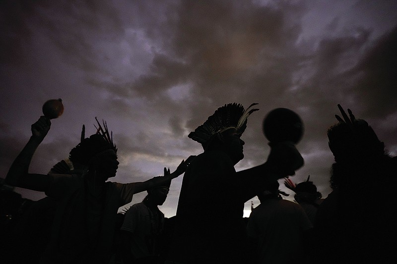 FiLE - Indigenous people take part in a march during the 18th annual Free Land Indigenous Camp, in Brasilia, Brazil, Wednesday, April 13, 2022.  A fast-expanding network of antennae is empowering Indigenous groups to use phones, video cameras and social media to galvanize the public and pressure authorities to respond swiftly to threats from gold miners, landgrabbers and loggers. (AP Photo/Eraldo Peres.File)