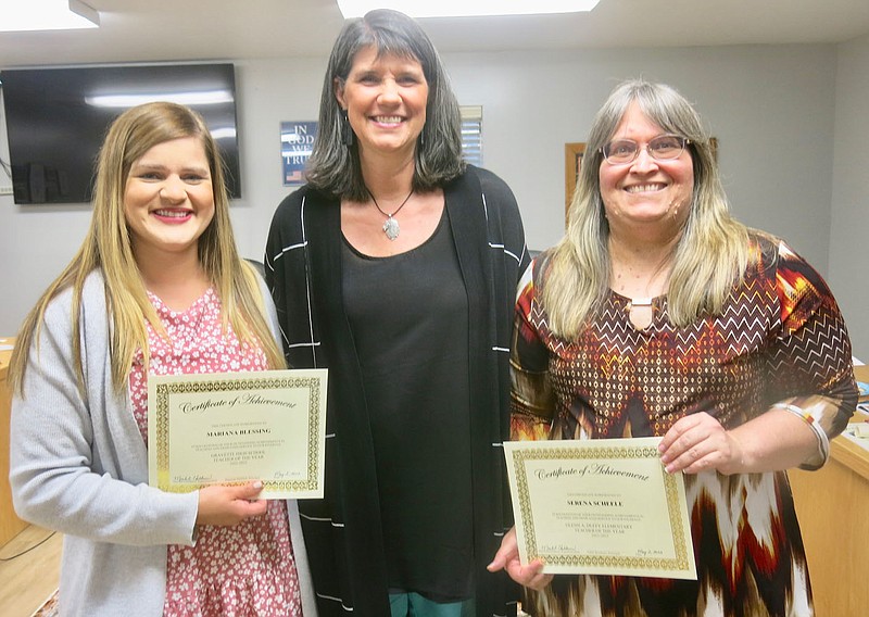 Westside Eagle Observer/SUSAN HOLLAND
Maribel Childress (center), superintendent of Gravette schools, poses with Mariana Blessing. Gravette High School Teacher of the Year, and Serena Scheele, Glenn Duffy Elementary Teacher of the Year, after presenting their certificates at a special board meeting Monday evening, May 2. Childress announced that Mariana Blessing has also been named District Teacher of the Year. Brad Leach, Gravette Middle School Teacher of the Year, and Steven Smith, Gravette Upper Elementary Teacher of the Year, were unable to attend the meeting.