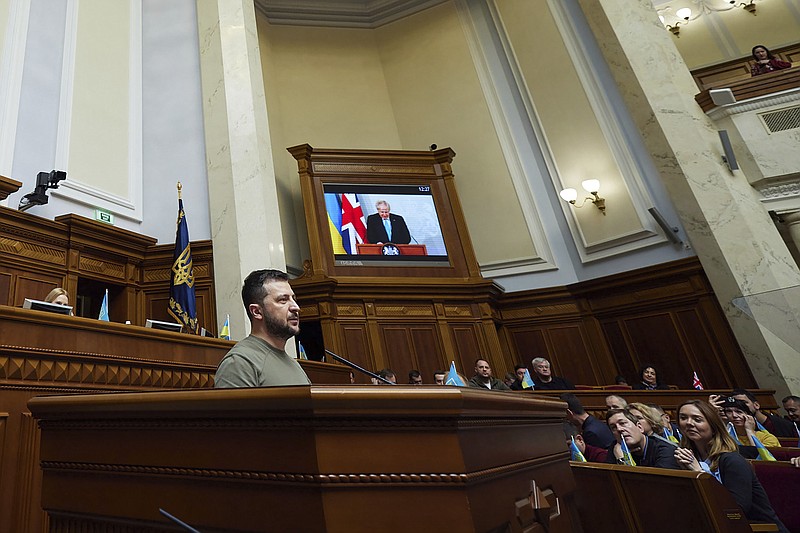 In this image released by the Ukrainian Presidential Press Office, Ukrainian President Volodymyr Zelenskyy speaks as a screen shows Britain's Prime Minister Boris Johnson during a session at Ukraine's parliament, in Kyiv, Ukraine, Tuesday, May 3, 2022. (Ukrainian Presidential Press Office via AP)