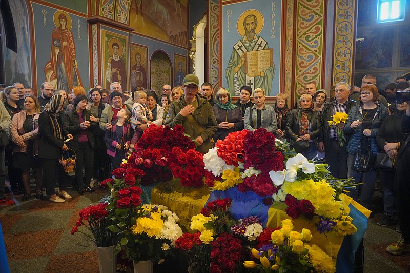 People pay their respect during the funeral ceremony for Ukrainian serviceman Ruslan Borovyk killed by the Russian troops in a battle in St Michael cathedral in Kyiv, Ukraine, Wednesday, May 4, 2022. (AP Photo/Efrem Lukatsky)