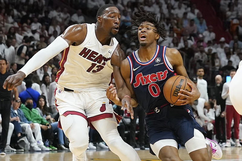 Philadelphia 76ers guard Tyrese Maxey (0) drives to the basket as Miami Heat center Bam Adebayo (13) defends, during the first half of Game 2 of an NBA basketball second-round playoff series, Wednesday, May 4, 2022, in Miami. (AP Photo/Marta Lavandier)