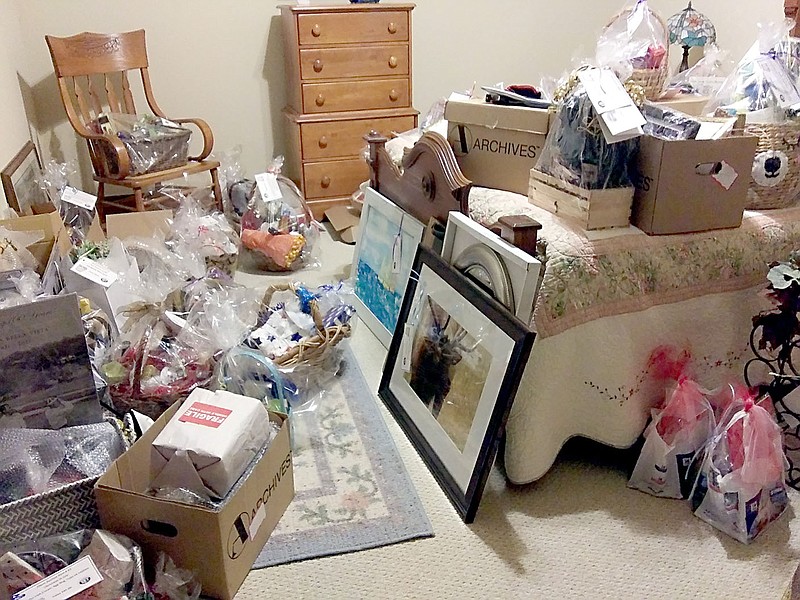 Photo submitted
Silent auction items are piling up in a spare room at volunteer Deb Sorensen's home.  The auction is part of the Bella Vista Charity Classic golf tournament scheduled for May 25 through 28.