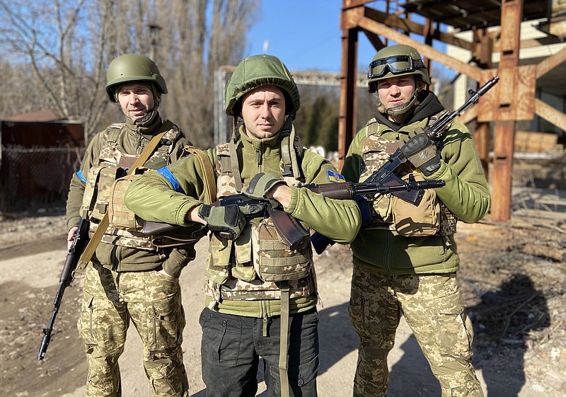 Taras Topolia (center) poses with fellow Antytila bandmates and Ukrainian army volunteers Serhiy Vusyk (left) and Dmytro Zholud. (Courtesy of Antytila)